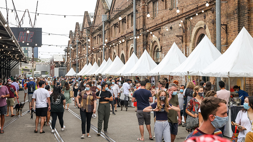 A crowd wanders through the shared pathway at the Carriageworks Christmas Twilight Market