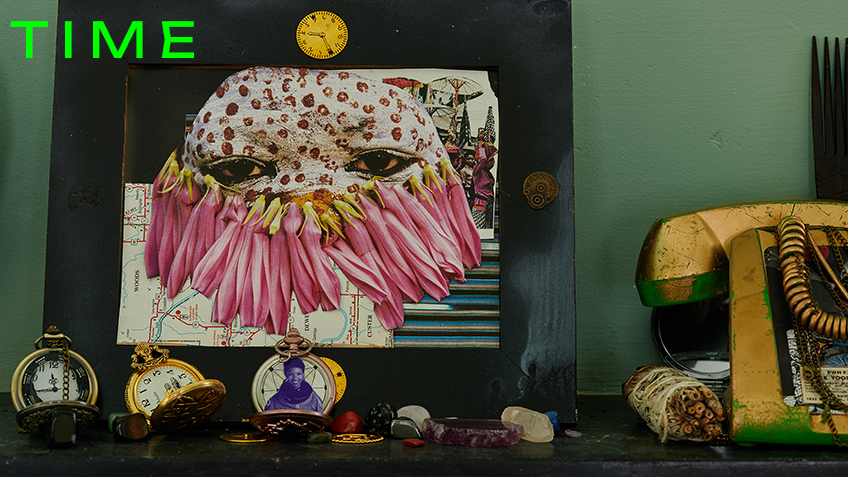 A framed collage picture sits on a table next to 3 pocket watches and a collection of crystals