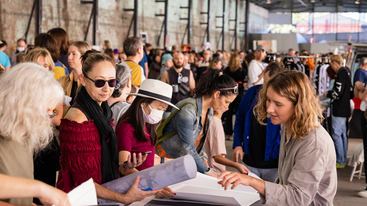 Crowds gathering around an artist's stall at Cut n Polish 2021 at Carriageworks.