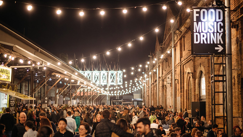 A crowd wanders through the Shared Pathway of Carriageworks during the Night Market