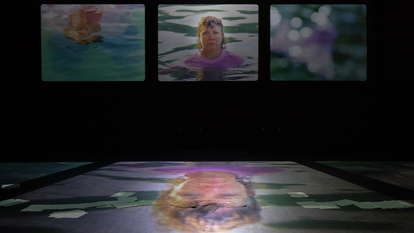 Three screens show Kaz Therese in water with a reflection of the same on the floor.