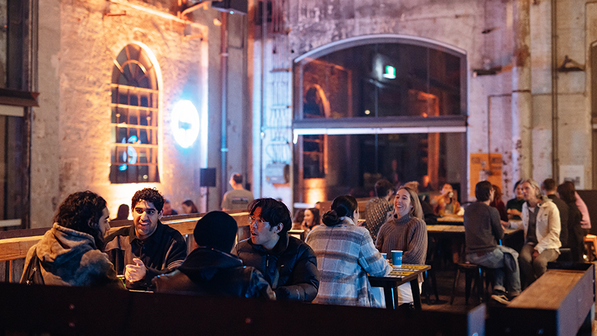 Guests sit at tables in the cafe space at Carriageworks.