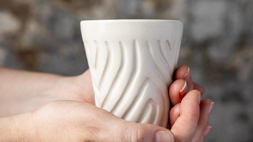 Ceramic cup made by artist Kevin 'Sooty' Welsh. Available at Carriageworks' SOUTHEAST Aboriginal Arts Market 2022.