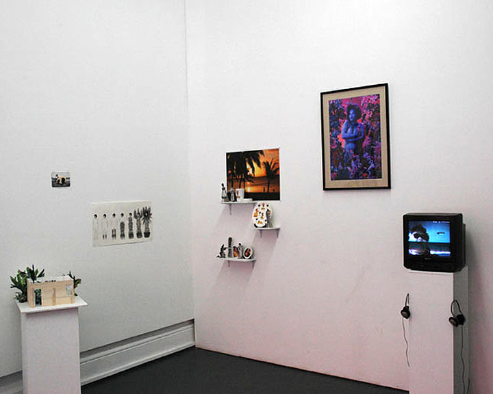 A selection of artistic works hanging on a white gallery wall