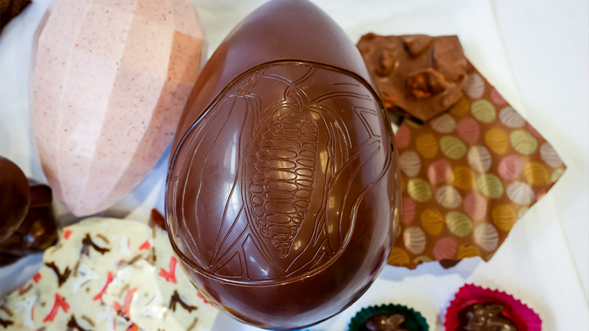 A large chocolate egg with a corn design on its face.